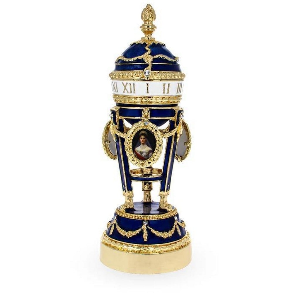 Picture Frames on Clock Royal Inspired Faberge Egg: Picture Frames on Clock Royal Inspired Faberge Egg Enameled Magnetic Catch Gold Plated Pewter Hand Painted Gift Boxed Dimensions: 5.65 Inches Tall x 2 Inches Wide (Egg on a stand) View