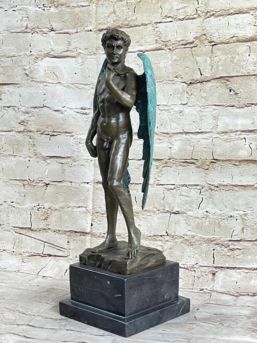 Patinated Winged Michelangelo's David With Angel Wings Bronze Sculpture - 15" x 6" (12lbs): A nude statue of David stands tall. His body is carefully crafted in a brown patina, exposing his muscular frame. His stomach is especially well-defined. His abdomen is cut and his hips curve outwards