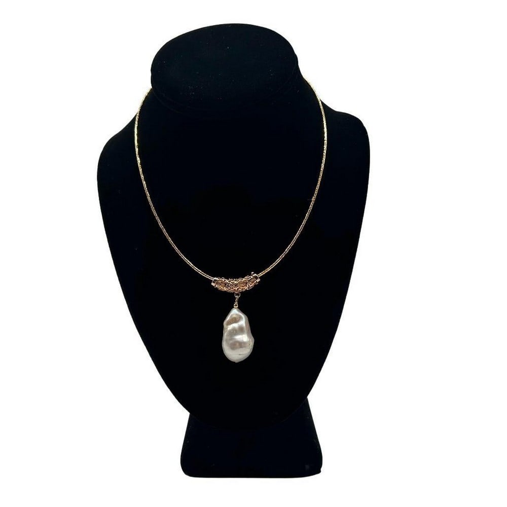 White Keshi Drop Pearl Pendant Necklace: White Keshi Drop Pearl Pendant Necklace This necklace features a 16mm x 28mm keshi pearl pendant fastened to a gold plated piece that is moveable. The chain is a flexible gold plated rope chain that