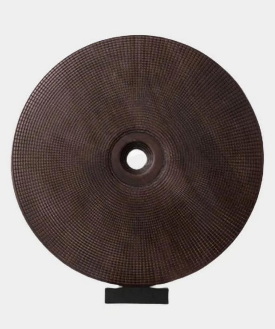 “Eclipse Form?? Woooden Abstract Sculpture: “Eclipse Form” Woooden Abstract Sculpture A hand-carved circular wooden sculpture featuring a rich, textured grain and a central opening, evoking the quiet drama of an eclipse. Mounted on a m