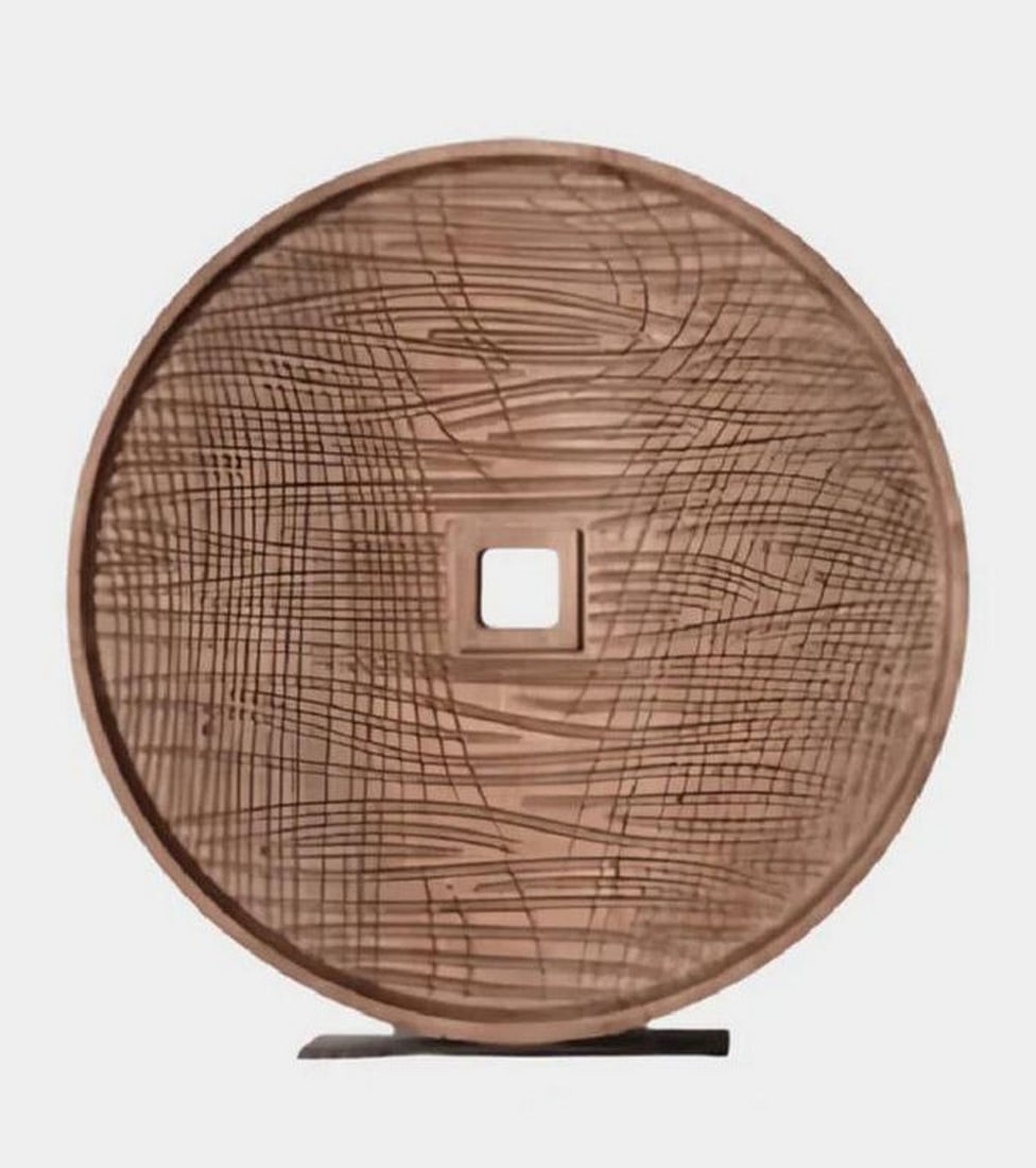 Hand-Carved Wooden Disc Sculpture with Geometric Detailing: Hand-Carved Wooden Disc Sculpture with Geometric Detailing This solid wood sculpture features a meticulously carved circular form with geometric line patterns radiating from a central square cutout. C