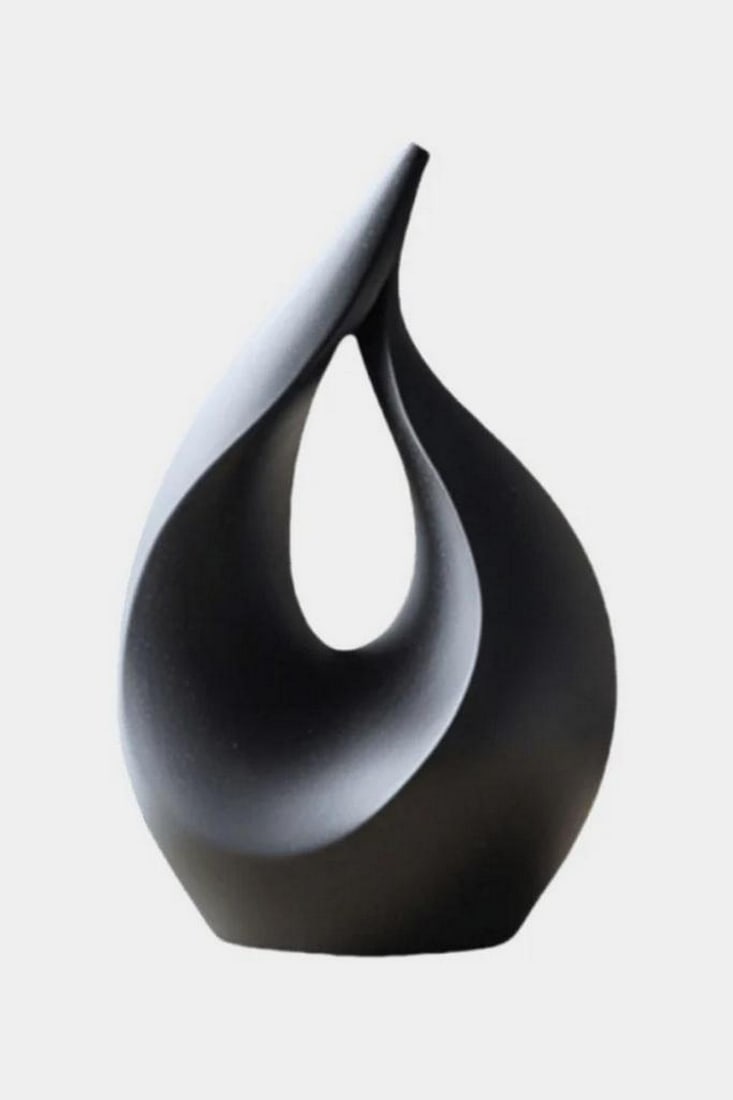 Eclipse in Motion – Abstract Blackwood Sculpture: Eclipse in Motion – Abstract Blackwood Sculpture This fluid teardrop sculpture, carved from deep-toned blackwood, captures the elegance of celestial movement. Its minimalist design and central nega