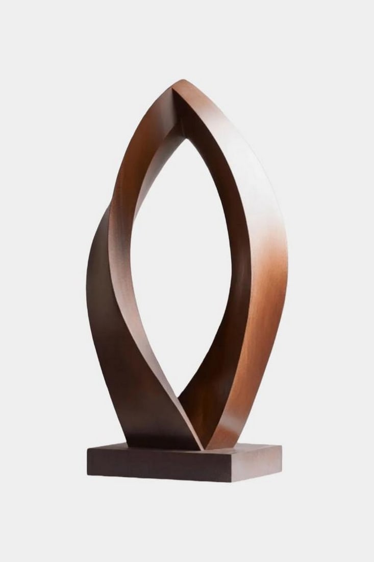 Dual Curve Leaf Wooden Sculpture: Dual Curve Leaf Wooden Sculpture A contemporary wooden sculpture featuring two smooth, sweeping curves that rise and meet in a graceful, leaf?like form. Its polished surface and warm wood tones