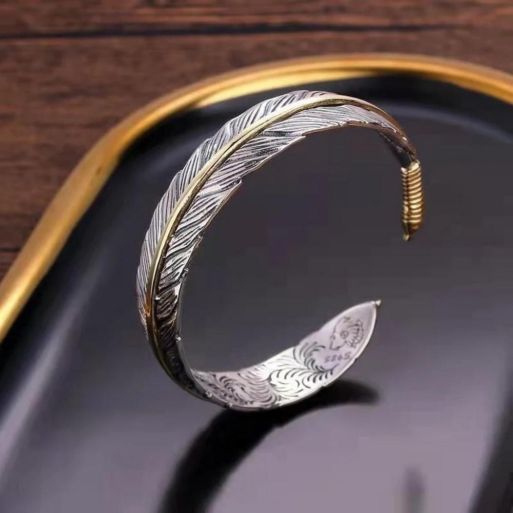 Feather Bangle of Freedom: Feather Bangle of Freedom Hand-forged by Mongolian artisans, the Feather Bangle embodies lightness, strength, and soulful craftsmanship. Sculpted from repurposed silver using traditional techniques,