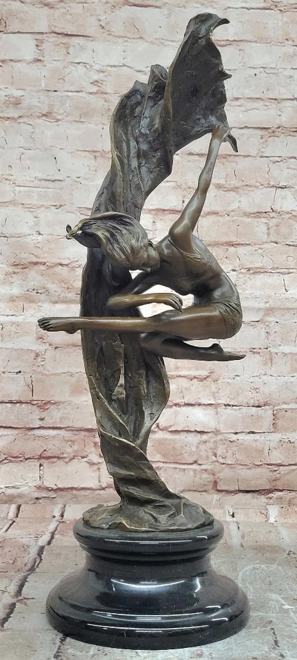 Gymnast Bronze Statue – 21" x 8": Gymnast Bronze Statue – 21" x 8" This original bronze statue depicts a gymnast captured midair at the peak of her motion, conveying balance, strength, and graceful poise. The figure is