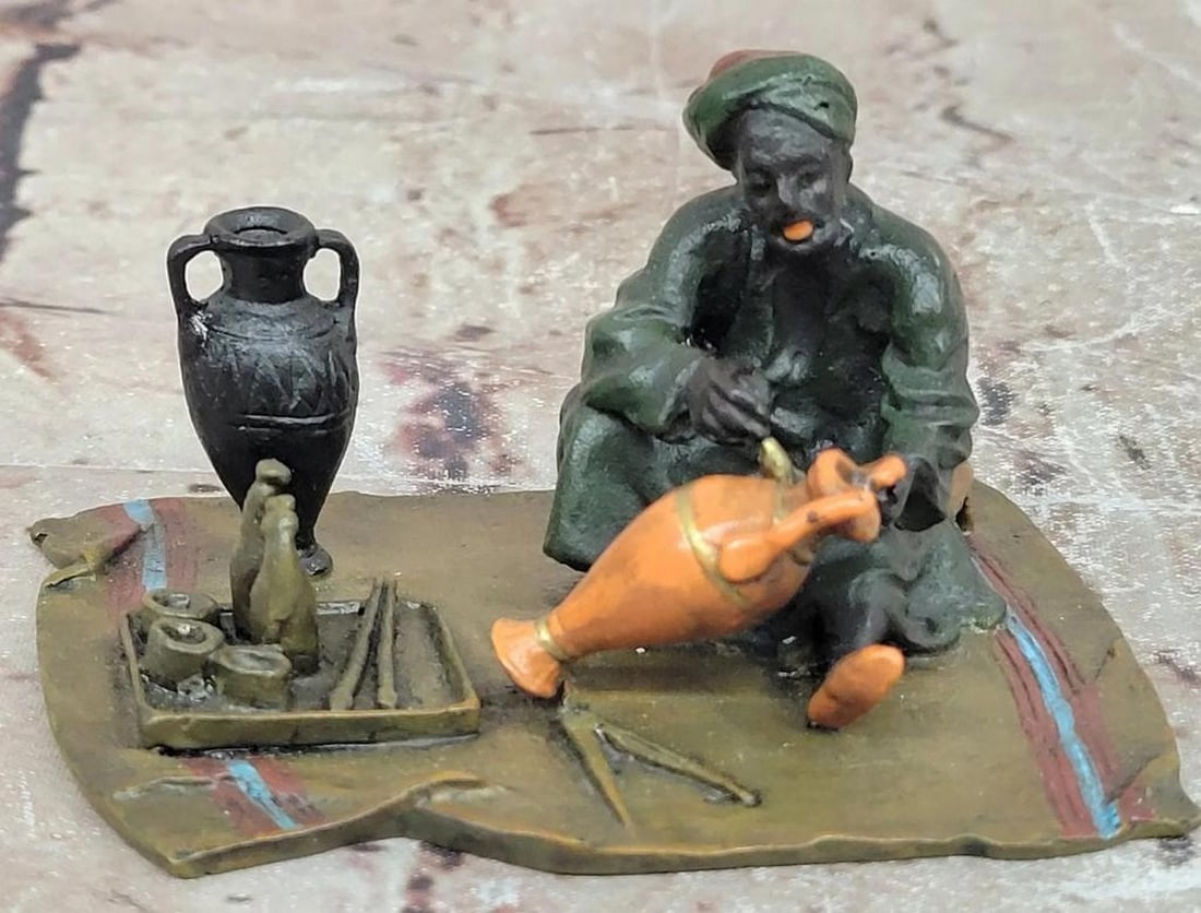 Bergman Inspired Bronze “Arabian Potter?? Cold-Painted Figure – 2.5" x 4": Bergman Inspired Bronze “Arabian Potter” Cold-Painted Figure – 2.5" x 4" This bronze figure depicts an Arabian potter at work, rendered in the style of Franz Bergman. The sculpture