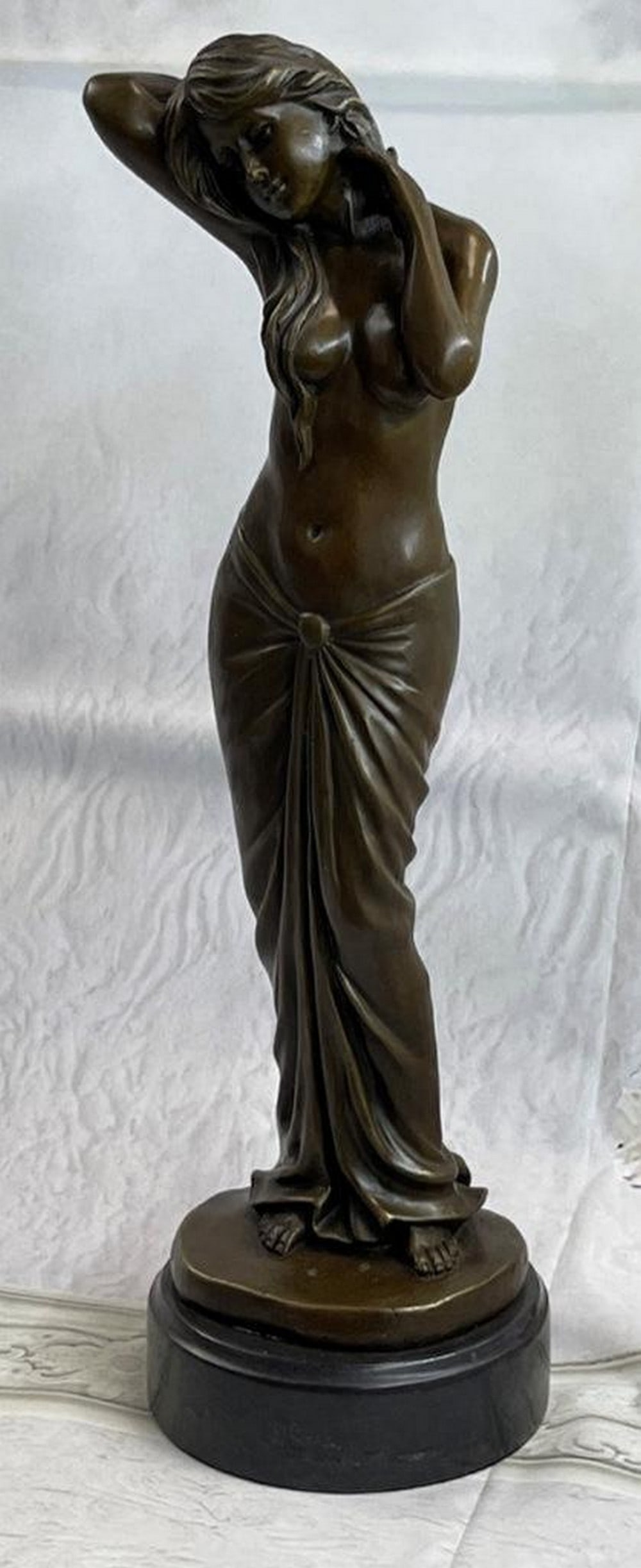 The Art And Beauty Of A Woman Bronze Sculpture: The Art And Beauty Of A Woman Bronze Sculpture The sculpture emphasizes the art and beauty of a woman. She is seen at liberty perhaps in the privacy of her chambers wearing only a ankle-length