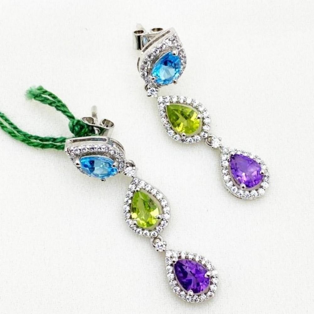 Amethyst, Peridot, Blue Topaz, and Zirconia Studded Earrings: Amethyst, Peridot, Blue Topaz, and Zirconia Studded Earrings These earrings have a stunning combination of colours with gorgeous purple amethyst, green peridot, and blue topaz. View Photos For
