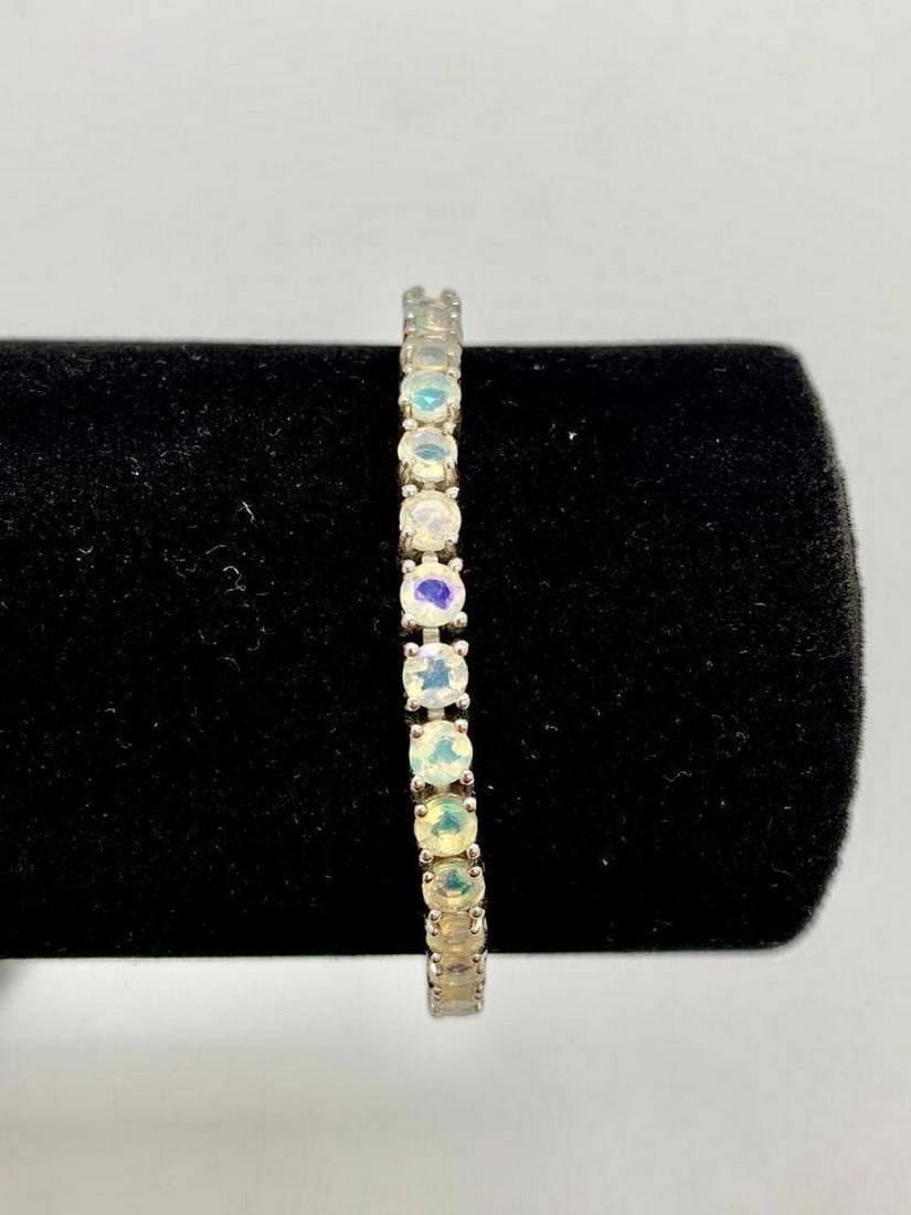11ct Multi-colored Round Cut Cubic Zerconia Bracelet set in 925 Silver: 11ct Multi-colored Round Cut Cubic Zerconia Bracelet set in 925 Silver. The bracelet contains a total of 37 stones, each at a carat weight of .3. Please view photos for further details. 