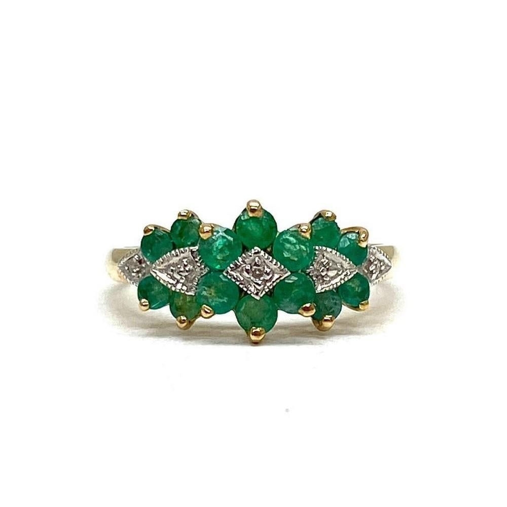 Detailed Ladies Size 7, 10k Gold, Emerald and Diamond Ring: This ring is completed with seven 0.04ct round cut emerald stones, and is mediated by four small, round cut diamonds. All set in a lustrous 10k gold ring. Please view photos for further details. 