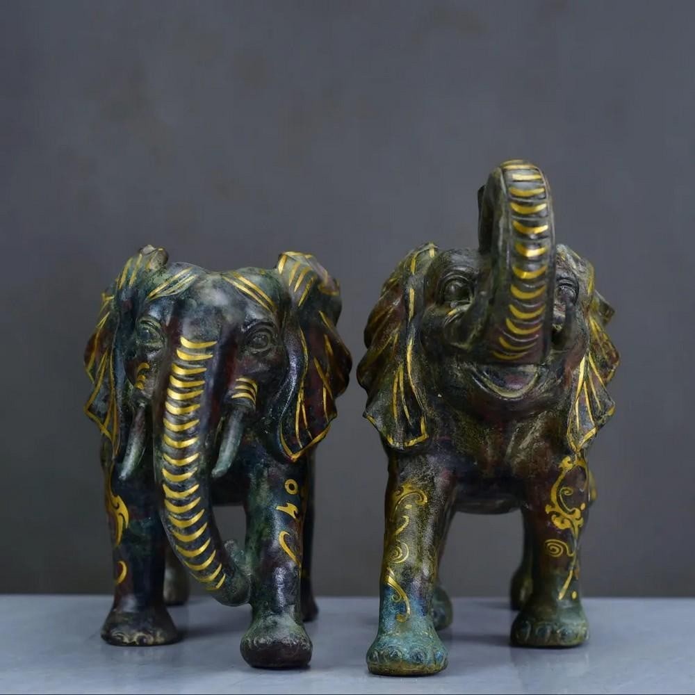 A Pair of Antique Chinese Bronze Elephant Statues: A Pair of Antique Chinese Bronze Elephant Statues This exquisite set features two hand-crafted Chinese antique bronze elephants, each showcasing intricate detailing and refined artistry. Representing