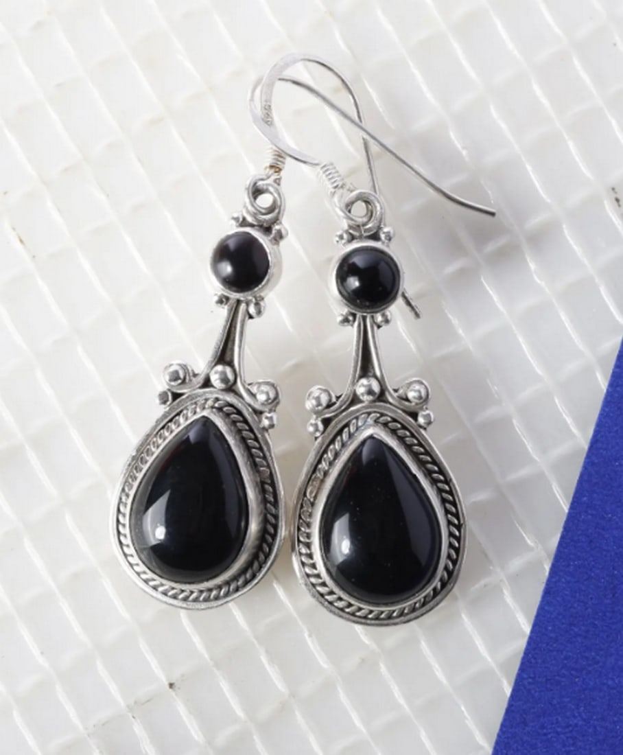 Midnight Onyx Hook Charms: Midnight Onyx Hook Charms Black onyx, a stone shrouded in mystery, is cherished as a protective amulet, believed to safeguard dreams. These elegant hook earrings feature teardrop-shaped black onyx se