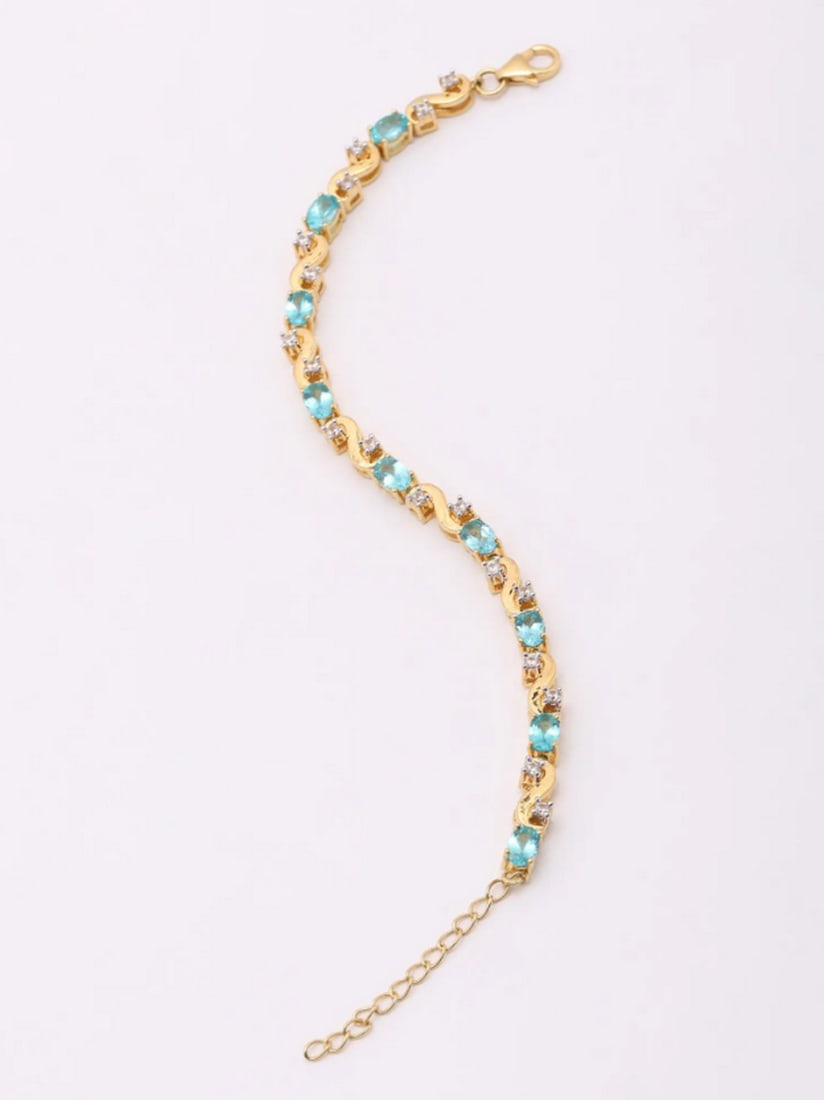 Serene Waters Apatite Bracelet: Serene Waters Apatite Bracelet Experience the essence of refined elegance with this exquisitely crafted bracelet. Designed to catch and reflect light with every movement, its faceted oval-shaped apat