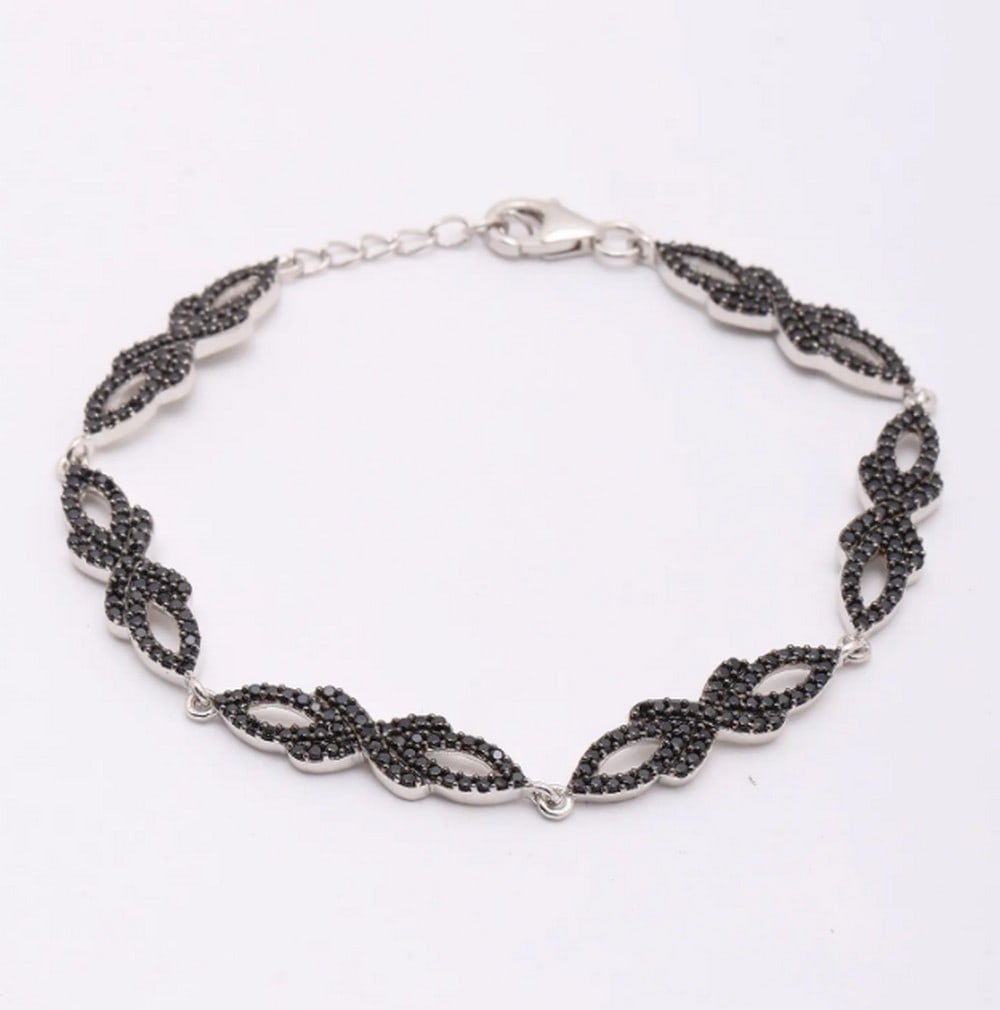 Midnight Spark Black Spinel Bracelet: Midnight Spark Black Spinel Bracelet Elevate your style with this sterling silver bracelet, featuring a striking arrangement of black spinel gemstones. The dark sparkle of each stone contrasts beauti