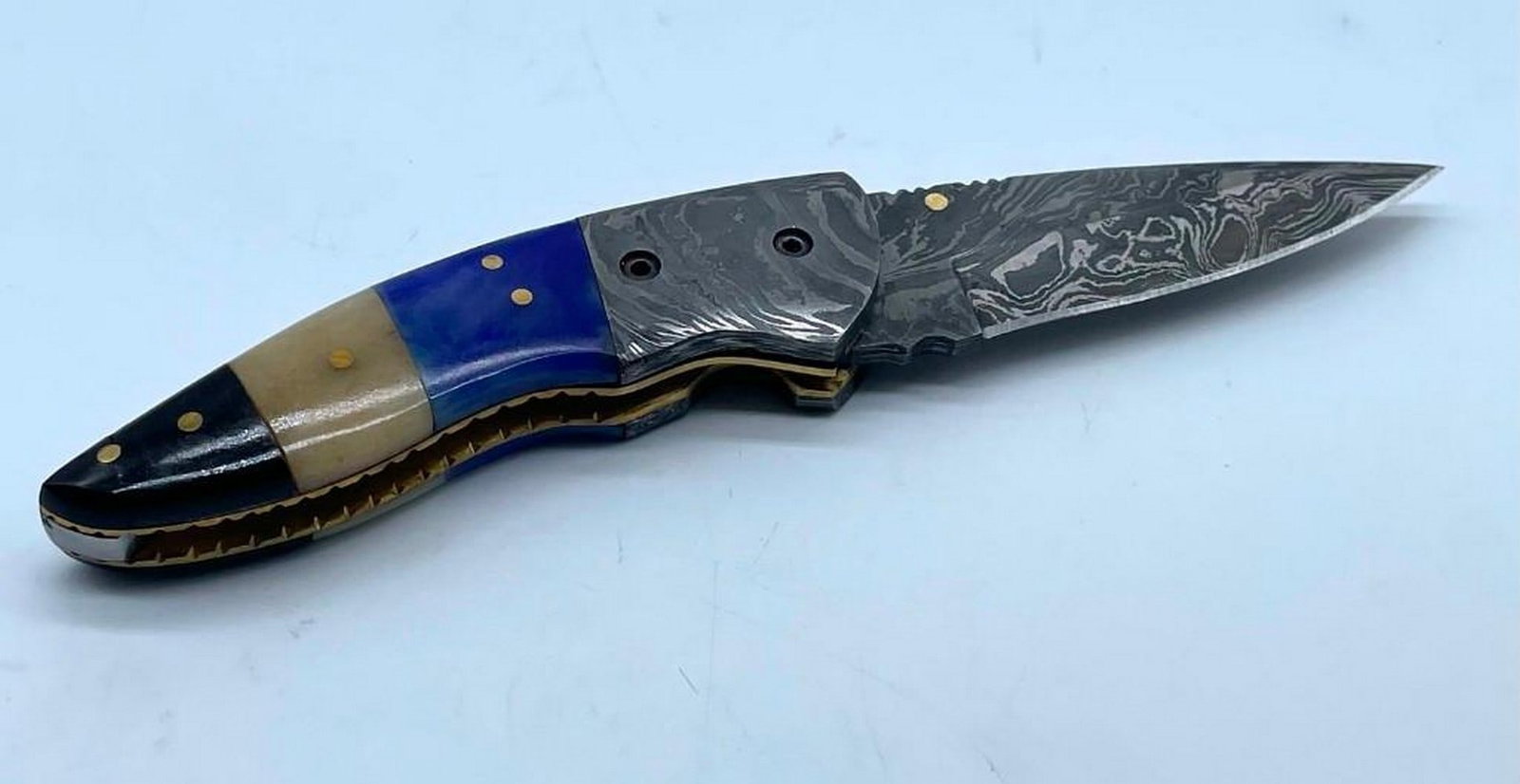 Tranquilities Folding Damascus Knife: Tranquilities Folding Damascus Knife. Damascus Steel Blade with 256 Layers on it. HARDNESS 56-60 H R C VERY HIGH QUALITY GENUINE LEATHER SHEATH View Photos For Further Details.