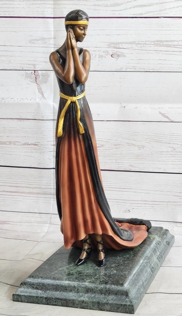 Dreamy Girl Bronze Sculpture: Dreamy Girl Bronze Sculpture She stands at the end of the runway. The camera bulbs flash as she spreads her arms to showcase her fashion forward outfit. She wears a long golden brown patina dress tha