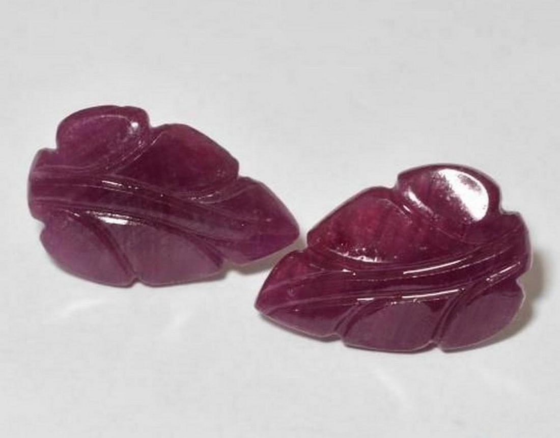 7.08 ct Natural Medium Dark-Purple Rubies, Carved Leaf, Opaque, Madagascar: 7.08 ct Natural Medium Dark-Purple Rubies, Carved Leaf, Opaque, Madagascar Natural ruby gemstones weighing a total of 7.08 ct, cut in a carved leaf shape with a medium dark-purple color. The gems meas