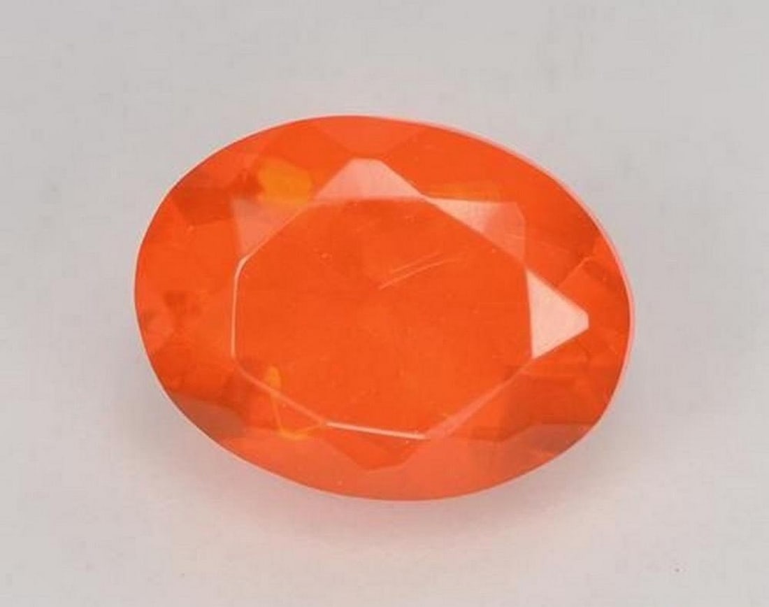0.83 ct Natural Fire Orange Fire Opal, Oval Facet, Transparent, Mexico: 0.83 ct Natural Fire Orange Fire Opal, Oval Facet, Transparent, Mexico Natural fire opal gemstone weighing 0.83 ct, cut in an oval facet shape with a vibrant fire orange color. The gem measures 8.17 x