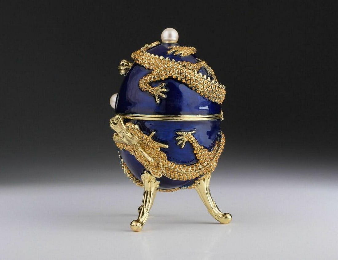 Royal Blue Faberge Inspired Music Playing Egg: Royal Blue Faberge Inspired Music Playing Egg Each crystal is handpicked and artistically placed on the piece. The trinket box has a magnetic fastener to secure the closure. The item is painted by ha