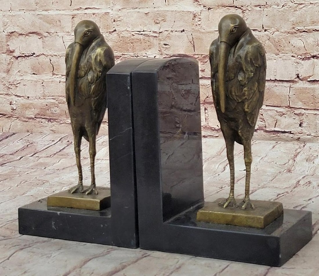 Pelican Bronze Bookends in the Inspired by Salvador Dalí - 9" x 6": Pelican Bronze Bookends in the Inspired by Salvador Dalí - 9" x 6" Each bronze bookend features a sculpted pelican, depicted with attention to form and feather detail. The figures emphasize