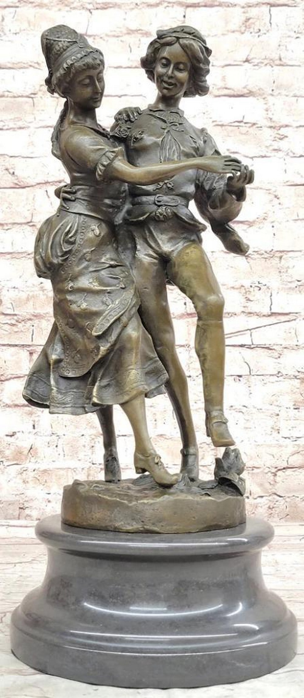 Loving Couple Dancing at Ball Inspired Bronze Statue - 18.5" x 8": Loving Couple Dancing at Ball Inspired Bronze Statue - 18.5" x 8" Immerse yourself in a world of love and longing with this captivating bronze sculpture. The poignant scene depicts a young w