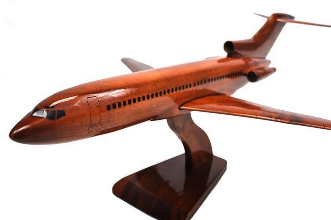 Boeing 727 Wooden Model Plane: Boeing 727 Wooden Model Plane This handcrafted scale model of the Boeing 727 is crafted from solid mahogany, showcasing meticulous detailing and a high-gloss finish that highlights the rich wood grain