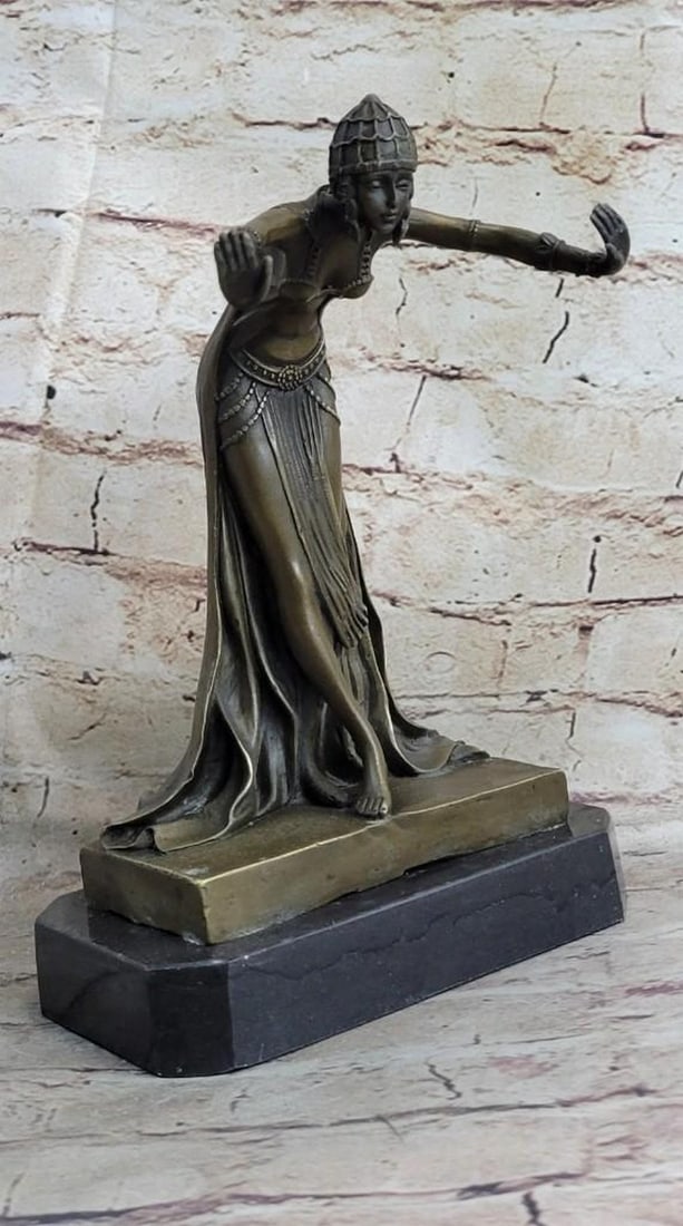Egyptian Princess Bronze Sculpture: Egyptian Princess Bronze Sculpture This Egyptian princess bows graciously with her hands out to her side as her long royal flowing dress cascades down her legs and gathers at her feet. On her head sh