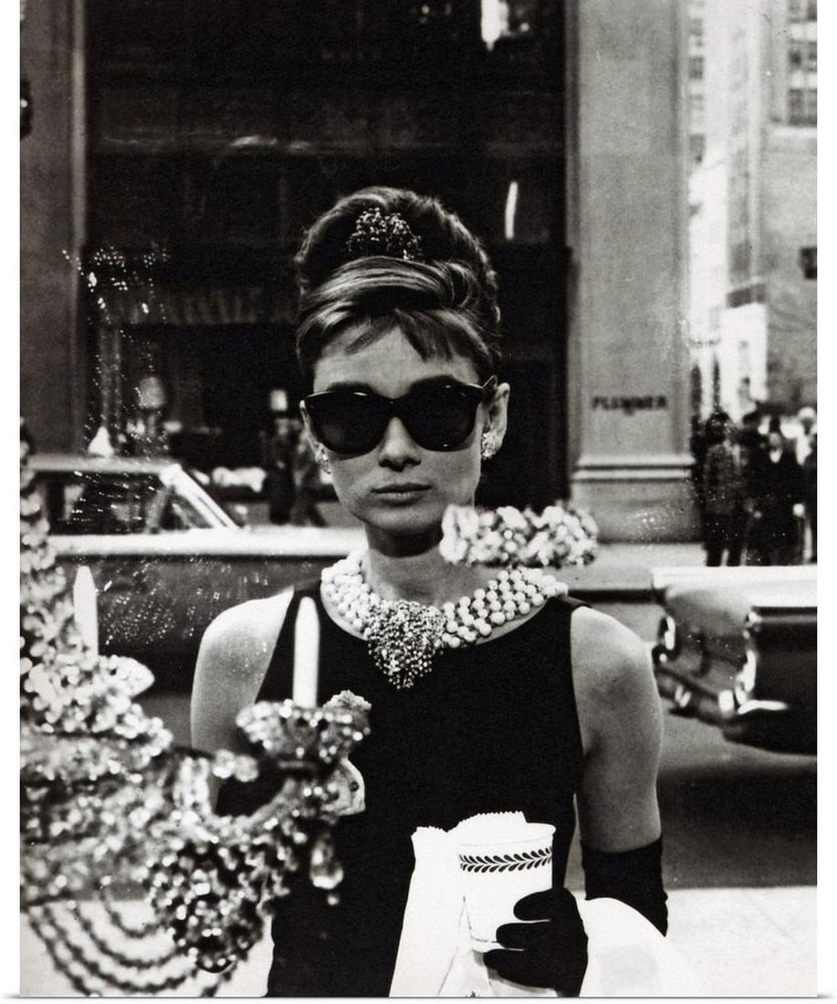 Audrey Hepburn Canvas Reproduction: Audrey Hepburn Canvas Reproduction Description: Movie still of the actress Audrey Hepburn wearing an elegant black dress and extravagant jewelry looking into the window of a shop. Dimensions: 16 inc