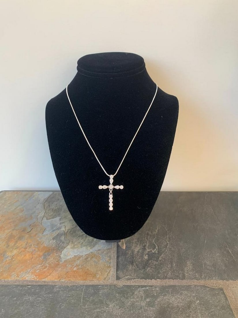 Radiant Faith Silver CZ Cross Pendant Necklace: Radiant Faith Silver CZ Cross Pendant Necklace Graceful and timeless, this silver necklace features a beautifully crafted cross pendant adorned with sparkling cubic zirconia stones. Each stone is care