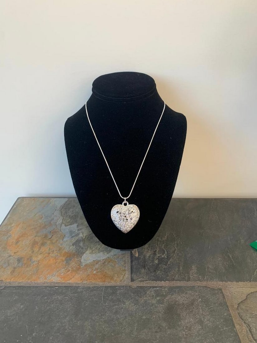 Pure Love Silver Heart Pendant Necklace: Pure Love Silver Heart Pendant Necklace Celebrate love and elegance with this silver heart pendant necklace. The polished heart pendant gleams with a smooth, reflective finish, offering a timeless des