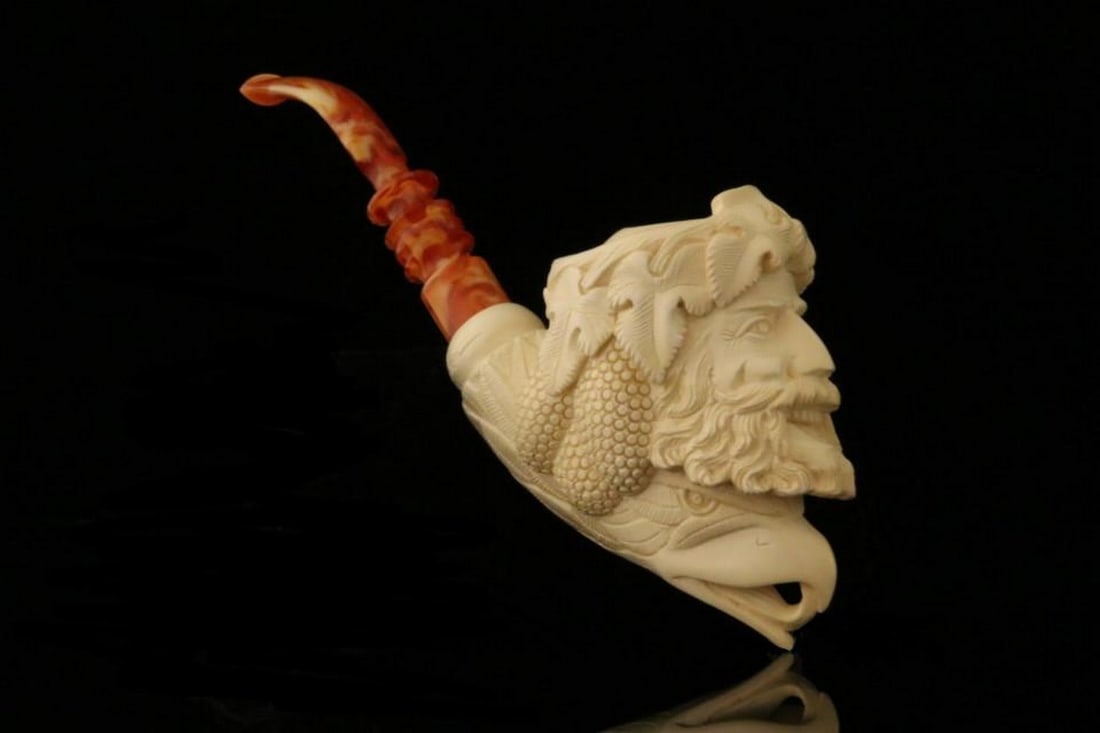 Bacchus with Eagle Figural Meerschaum Pipe with Fitted Case: Bacchus with Eagle Figural Meerschaum Pipe with Fitted Case This hand-carved meerschaum pipe features an intricate Bacchus and eagle design, showcasing exceptional craftsmanship and attention to deta