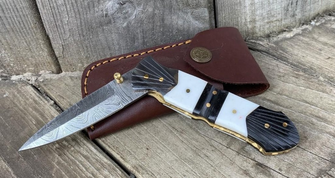 7.5" Silent Justice Folding Damascus Knife: 7.5" Silent Justice Folding Damascus Knife Custom Handmade Damascus Steel Hunting, Camping & Folding Knife Handle Mother of Pearl With Bull Horn Bolster. Damascus Steel Blade with 256 Layers
