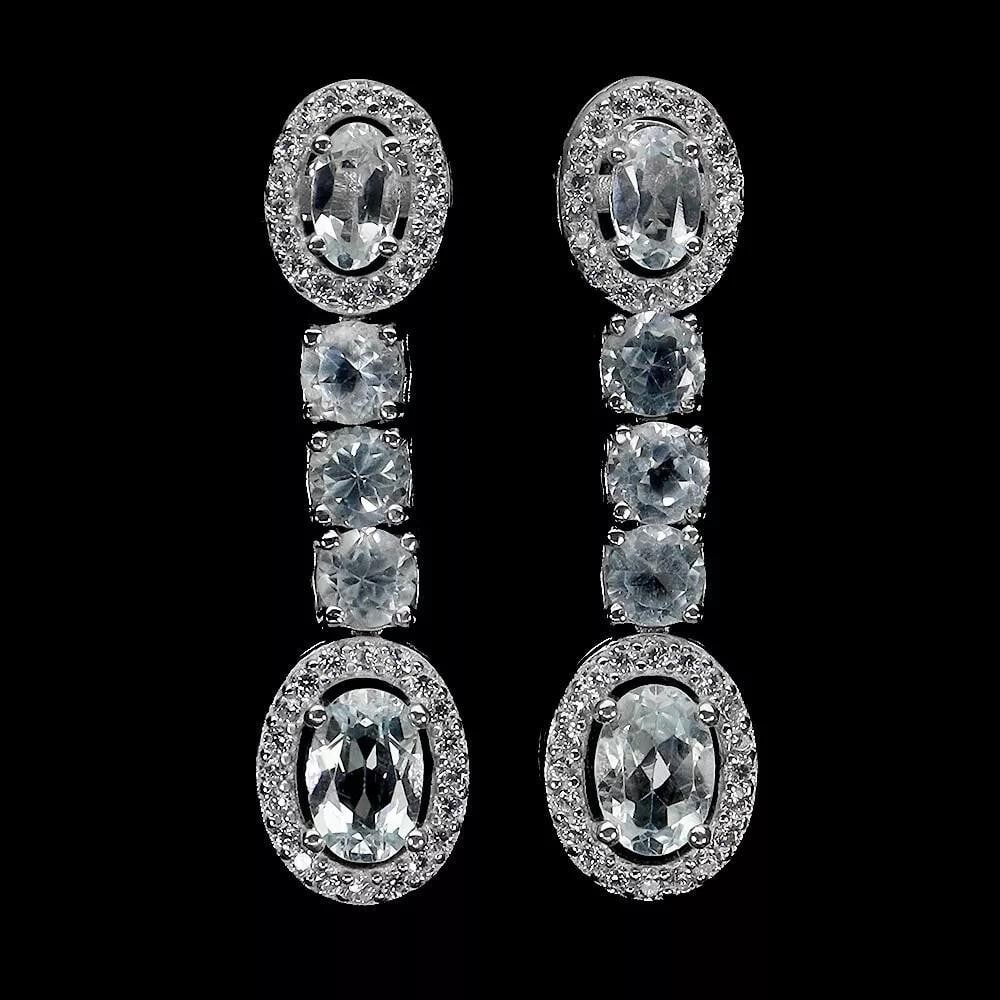 Oval Blue Topaz 925 Sterling Dangle Silver Earrings: Oval Blue Topaz 925 Sterling Dangle Silver Earrings Add a pop of color to your jewelry collection with these beautiful 925 sterling silver earrings featuring oval blue topaz gemstones, each measuring