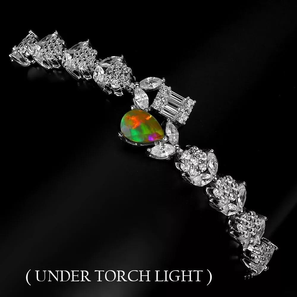 7" Fire Opal 925 Sterling Silver Bracelet: 7" Fire Opal 925 Sterling Silver Bracelet This exquisite 925 sterling silver bracelet features a stunning pear-shaped fire opal, measuring 7x5mm. The natural gemstone showcases a captivating play