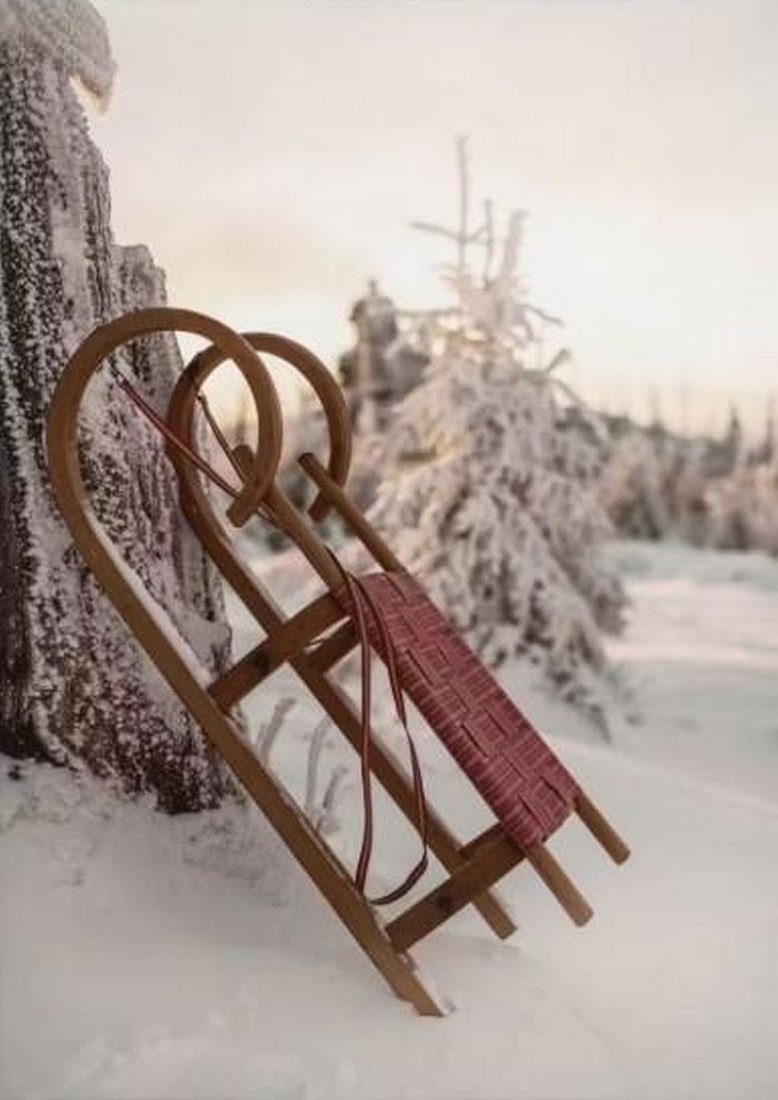 Red Sleigh in Winter Canvas Print: Red Sleigh in Winter Canvas Print An artwork showing a red wooden sleigh resting against a snow-covered tree, with snowy trees and a quiet winter sky in the background. The scene captures a calm seas