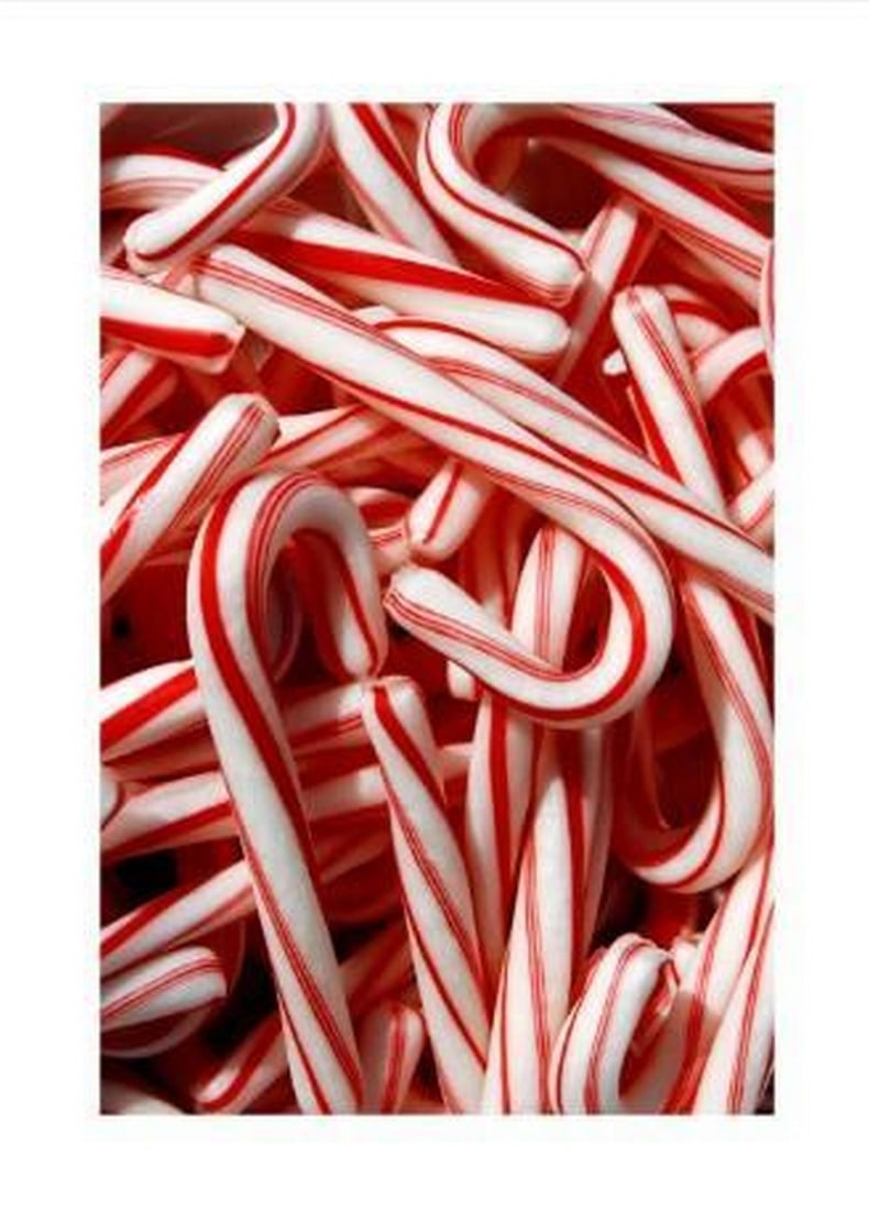 Peppermint Holiday Poster Print: Peppermint Holiday Poster Print An artwork showing red and white striped candy canes piled together, creating a festive and cheerful holiday scene. The print includes a white margin framing the desig