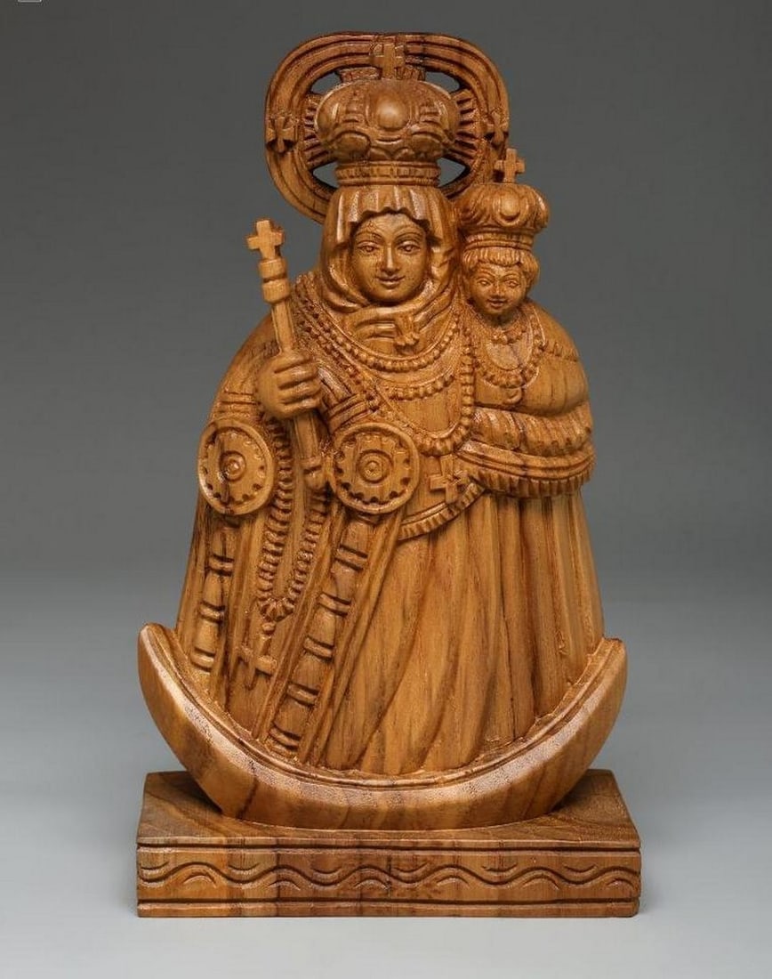 8" Velankanni Mother Mary Wood Carved Statue: 8" Velankanni Mother Mary Wood Carved Statue This finely handcrafted wooden statue depicts Our Lady of Velankanni holding the Christ Child, capturing her gentle expression and graceful form in