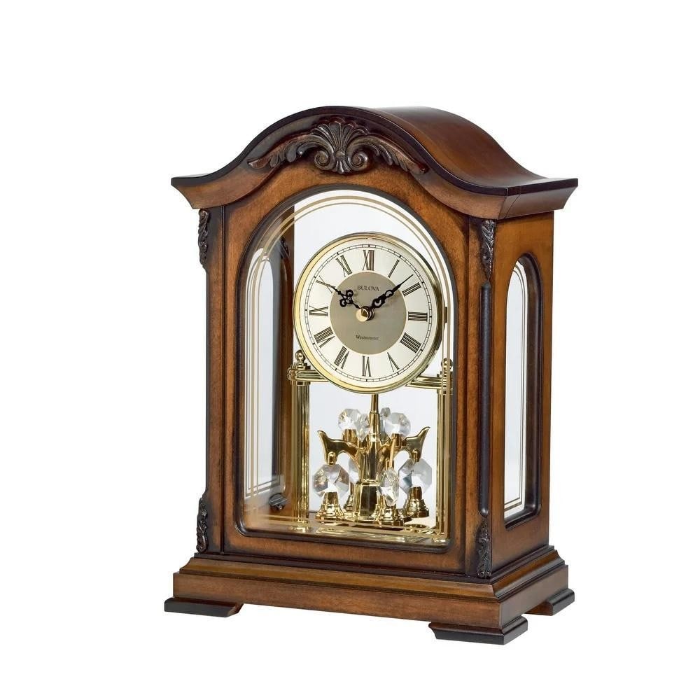 Walnut Chiming Wooden Mantel Clock: Walnut Chiming Wooden Mantel Clock This chiming mantel clock features a solid wood case with an old-world walnut finish. It plays the Westminster melody on the hour and includes a revolving pendulum f