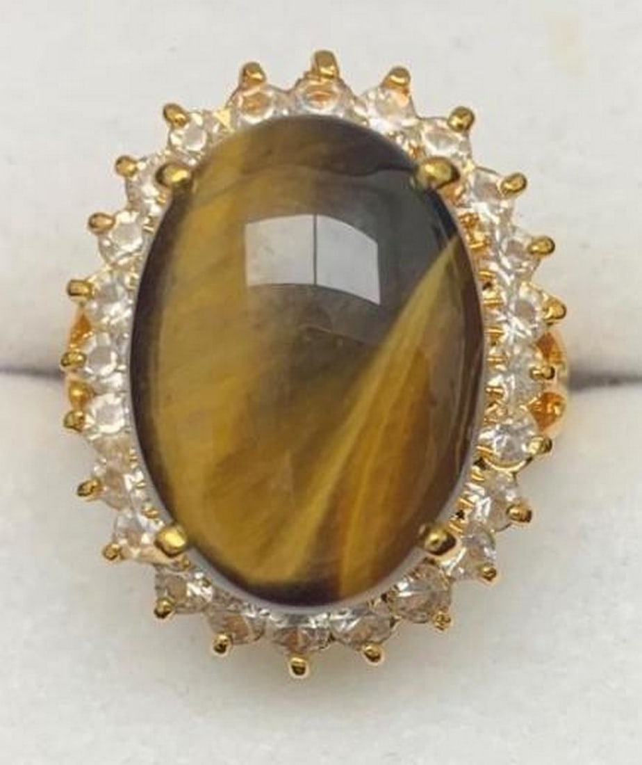 Extravagant Tiger Eye Stone Ring: Extravagant Tiger Eye Stone Ring This Tiger Eye stone ring is set in triangular Austrian Crystals on an 18KTGP band. Tiger eye stones are known as a protection stone that is said to be successful in