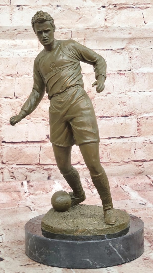 Soccer Mid-fielder Original Bronze Statue - 11" x 5": Soccer Mid-fielder Original Bronze Statue - 11" x 5" This dynamic bronze sculpture captures the intense energy of a soccer player in mid-action, celebrating the passion and focus of the beau