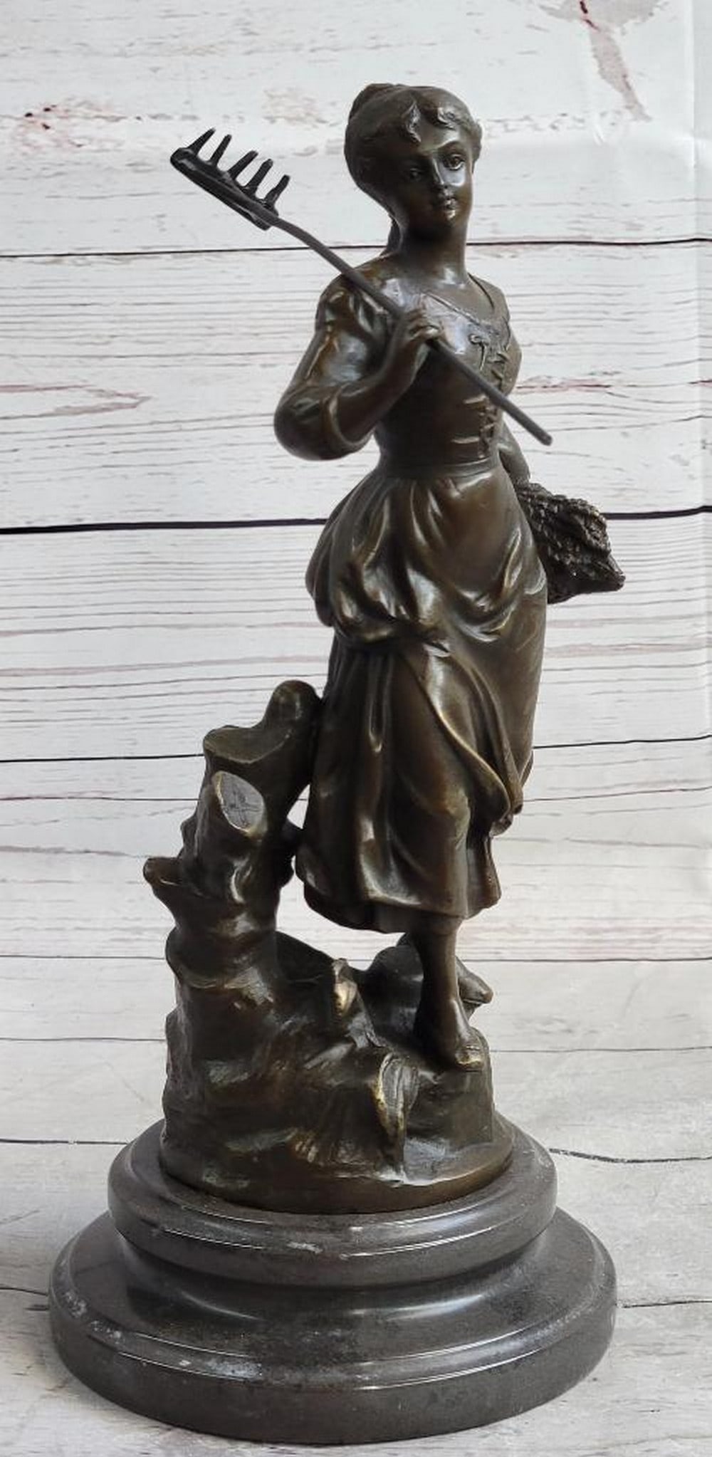 Young Girl with Wheat Bronze Sculpture by Desmeure – 12" x 6": Young Girl with Wheat Bronze Sculpture by Desmeure – 12" x 6" This reproduction bronze sculpture depicts a young girl returning from work in the wheat fields, holding a rake in one hand and