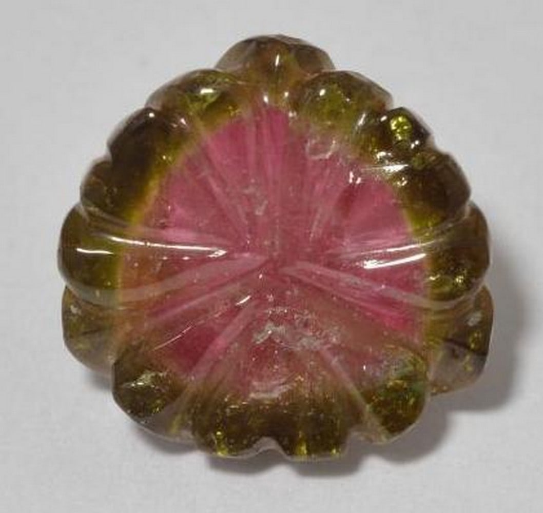 Watermelon Tourmaline Carved Flower Gemstone: Watermelon Tourmaline Carved Flower Gemstone This captivating loose gemstone is carved into a delicate flower design from natural watermelon tourmaline, showcasing a beautiful gradient of pink,