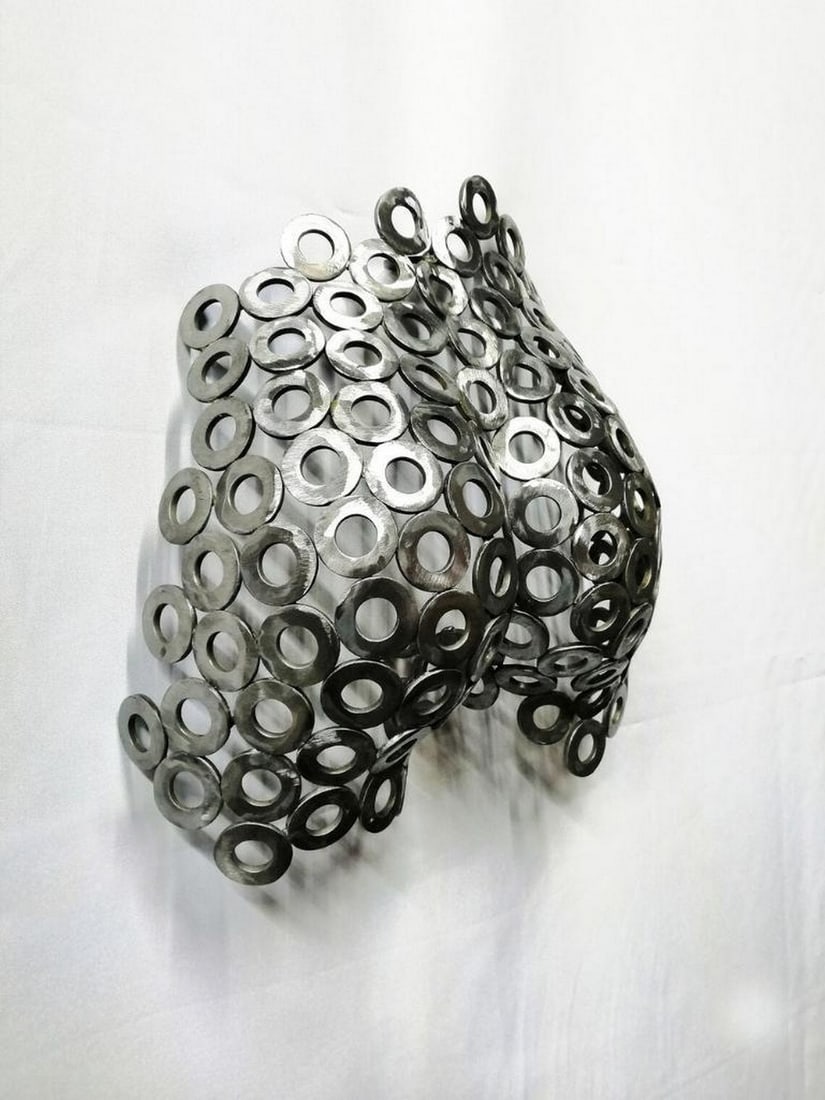 Grace in Metal Sculpture: Grace in Metal Sculpture This elegant abstract metal sculpture of a woman captures the beauty of the female form with flowing, refined lines. Handcrafted and welded by artisans, each metal piece is me