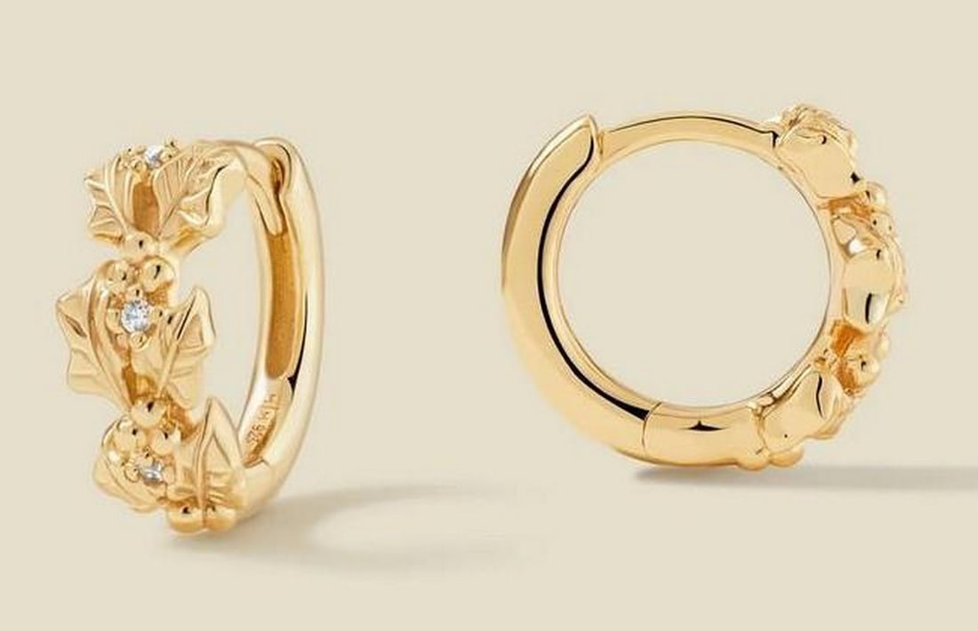 Gold Vermeil December Holly CZ Huggie Earrings: Gold Vermeil December Holly CZ Huggie Earrings These huggie earrings feature detailed December holly silhouettes accented with prong-set cubic zirconia. Lightweight and secure with a hinged closure, t