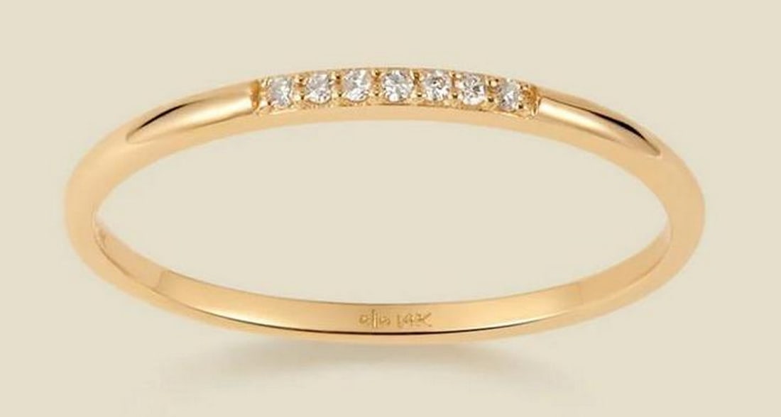 Celeste Diamond Band: Celeste Diamond Band Inspired by the brilliance of the night sky, this delicate 14k solid gold band features seven round-cut diamonds in a radiant line. Whether worn alone for a subtle shimmer or stac