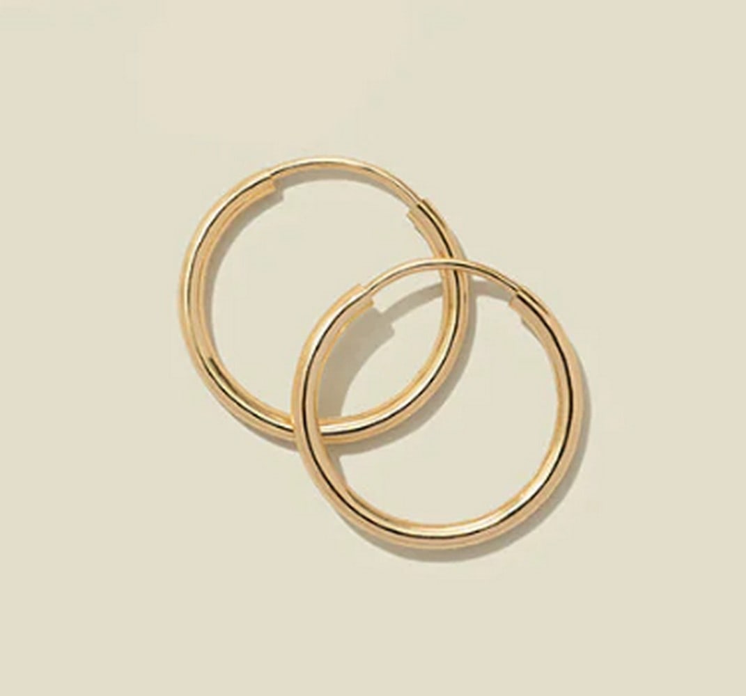 14k Solid Gold Live In Hoop Earrings: 14k Solid Gold Live In Hoop Earrings Timeless yet modern, this refined take on our beloved Live-In Hoops is pure gold. Crafted from 14k solid gold, these infinity-style hoops are designed for