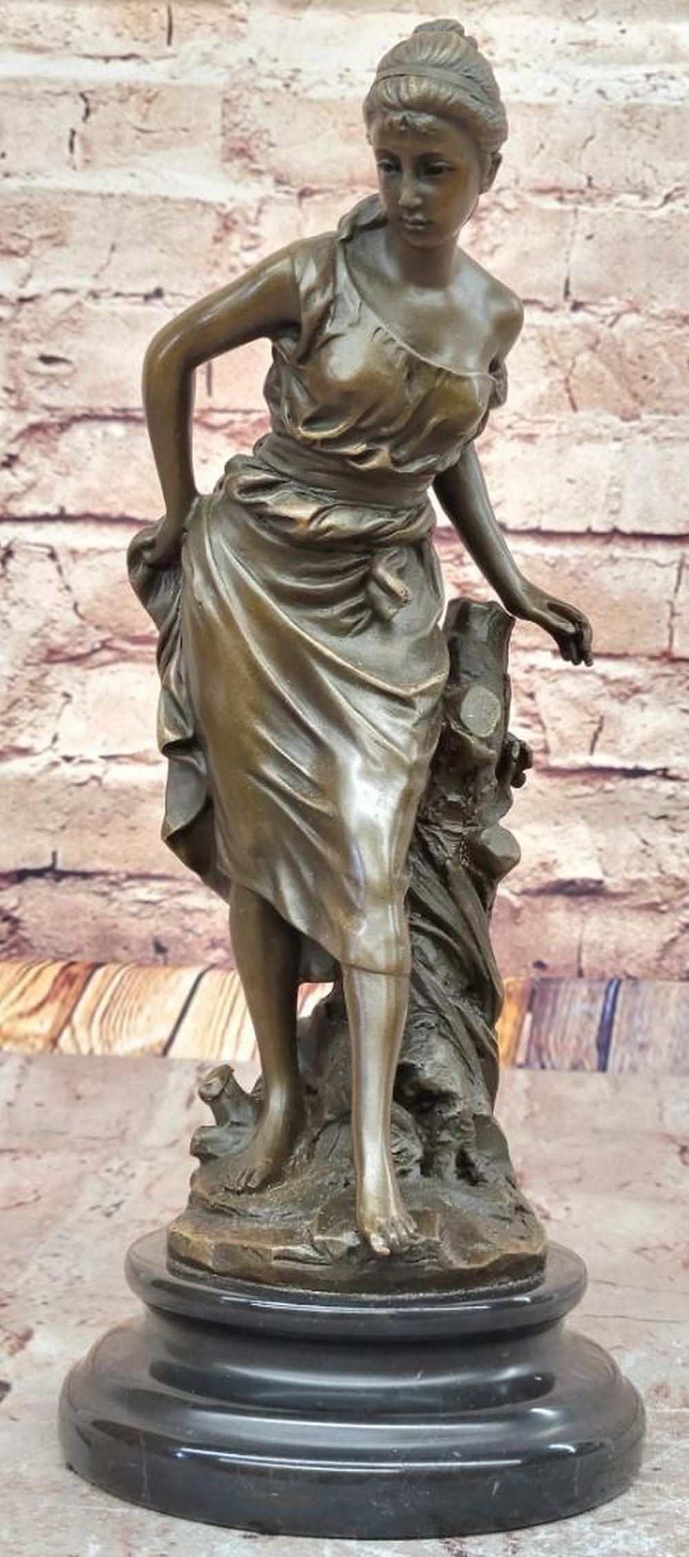 Elegant Women in Gown Inspired Bronze Statue - 11.5" x 5": Elegant Women in Gown Inspired Bronze Statue - 11.5" x 5" This elegant bronze sculpture by A. Carrier beautifully captures the grace of a young woman draped in flowing garments. Her poised s