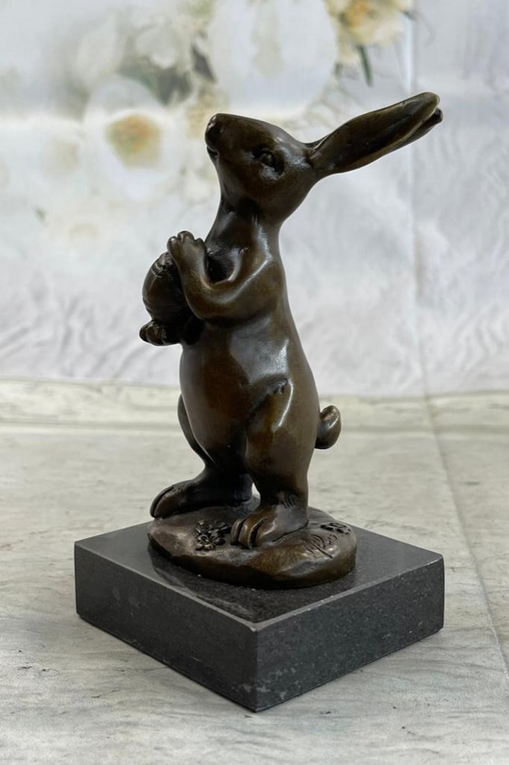 Cuddly Little Bunny Holding a Basket Full of Carrots Bronze Statue: Cuddly Little Bunny Holding a Basket Full of Carrots Bronze Statue. This cute lil fellow looks up with the sweetest look and holds an egg in his tiny arms. This little rabbit is the perfect touch of