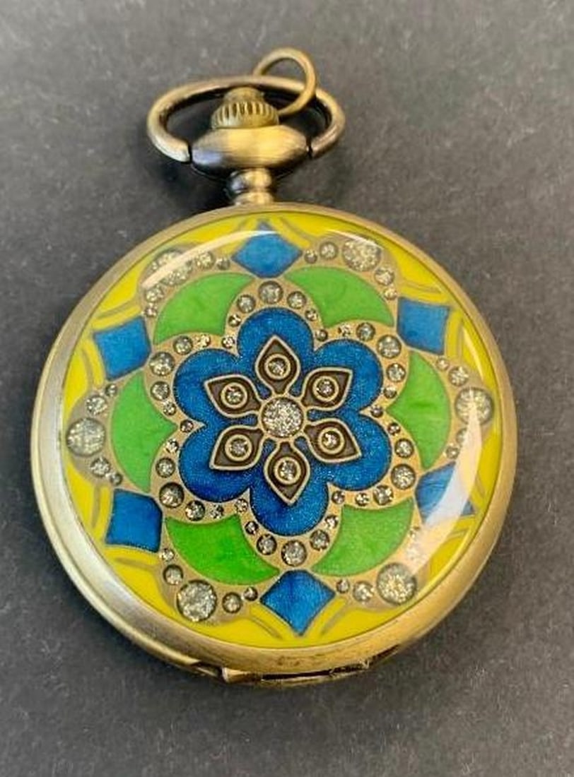 Pocket Watch with Carved Detail: Pocket Watch with Carved Detail This unique bronze-toned pocket watch features intricate carvings on one side, showcasing elegant vintage-style craftsmanship. The other side displays a vibrant