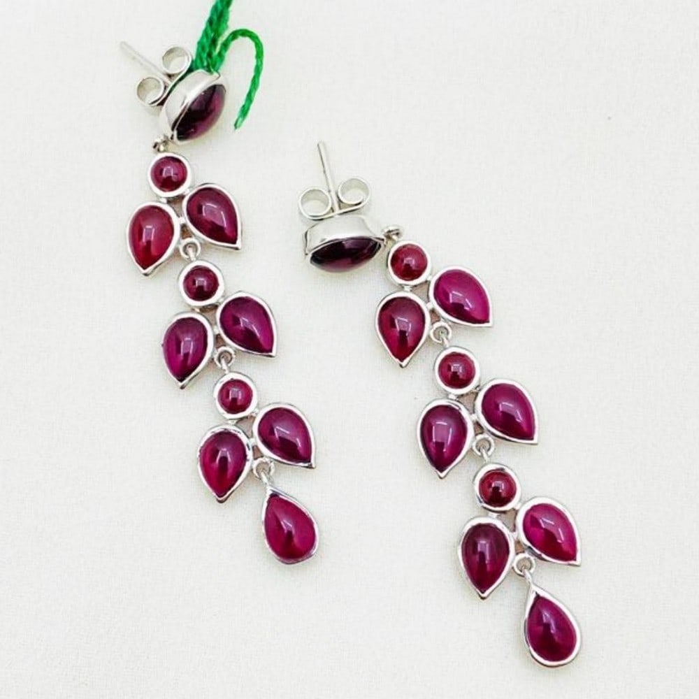 Studded Garnet Cabochon on 925 Sterling Silver Earrings: Studded Garnet Cabochon on 925 Sterling Silver Earrings Introducing our exquisite earrings, adorned with 20 studded Garnet cabochons, set meticulously within a 925 sterling silver mounting. Each